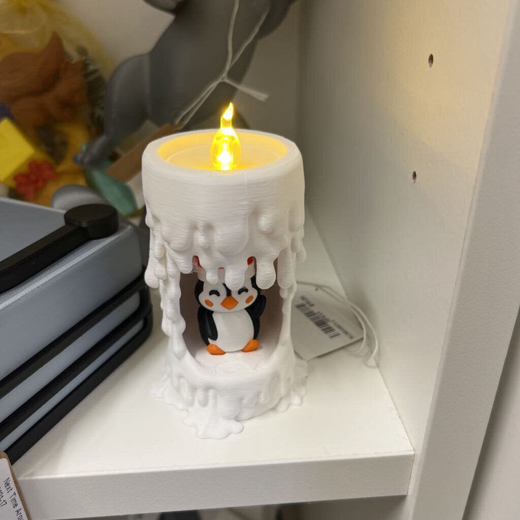 Penguin inside a melted candle