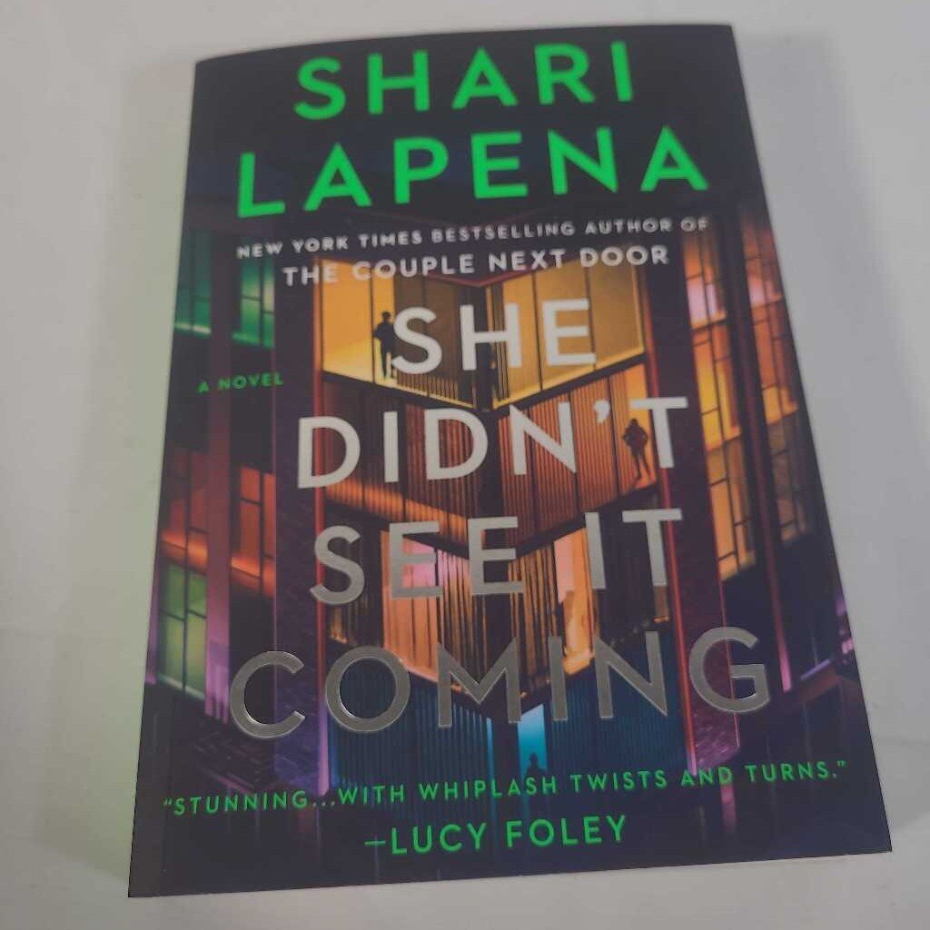 SHE DIDN'T SEE IT COMING - SHARI LAPENA