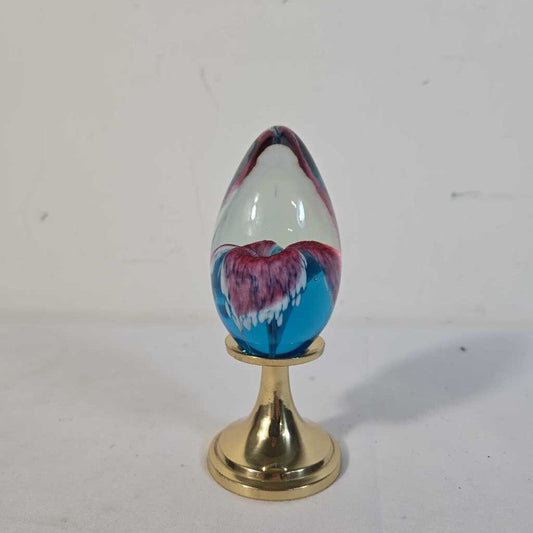 GLASS EYE STUDIO EGG SHAPE PAPERWEIGHT ON BRASS STAND